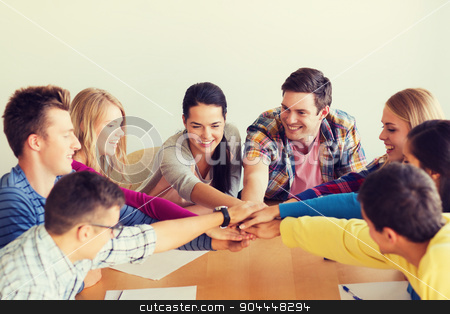 To use this stock image in your creative project, please select the size you need over to the right and click the "Add to Cart" button.
Your downloaded image will come with the Cutcaster watermark removed so don’t worry about the watermark you see on this page. group of smiling students with hand on top stock photo, education, teamwork and people concept - smiling students with papers putting hands on top of each other by Syda Productions