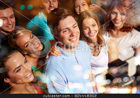 To use this stock image in your creative project, please select the size you need over to the right and click the "Add to Cart" button.
Your downloaded image will come with the Cutcaster watermark removed so don’t worry about the watermark you see on this page. friends with smartphone taking selfie in club stock photo, party, technology, nightlife and people concept - smiling friends with smartphone and monopod taking selfie in club by Syda Productions