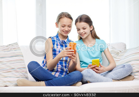 To use this stock image in your creative project, please select the size you need over to the right and click the "Add to Cart" button.
Your downloaded image will come with the Cutcaster watermark removed so don’t worry about the watermark you see on this page. happy girls with smartphones sitting on sofa stock photo, people, children, technology, friends and friendship concept - happy little girls with smartphones sitting on sofa at home by Syda Productions