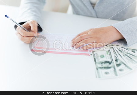 To use this stock image in your creative project, please select the size you need over to the right and click the "Add to Cart" button.
Your downloaded image will come with the Cutcaster watermark removed so don’t worry about the watermark you see on this page. close up of hands with lottery ticket and money stock photo, business, finance, gambling and people concept - close up of woman hands filling lottery ticket and us dollar money by Syda Productions