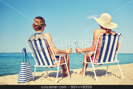 To use this stock image in your creative project, please select the size you need over to the right and click the "Add to Cart" button.
Your downloaded image will come with the Cutcaster watermark removed so don’t worry about the watermark you see on this page. happy women sunbathing in lounges on beach stock photo, summer vacation, travel and people concept - happy women drinking beer and sunbathing in lounges on beach by Syda Productions