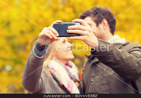 To use this stock image in your creative project, please select the size you need over to the right and click the "Add to Cart" button.
Your downloaded image will come with the Cutcaster watermark removed so don’t worry about the watermark you see on this page. couple taking selfie with smartphone in park stock photo, technology, love, relationship and people concept - close up of smiling couple taking selfie with smartphone in autumn park by Syda Productions