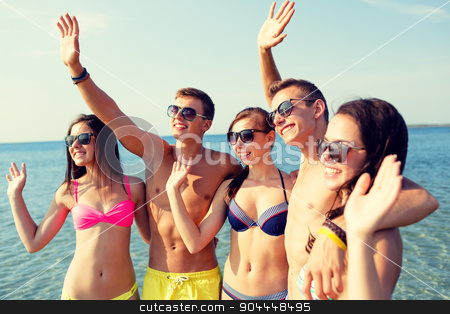 To use this stock image in your creative project, please select the size you need over to the right and click the "Add to Cart" button.
Your downloaded image will come with the Cutcaster watermark removed so don’t worry about the watermark you see on this page. smiling friends in sunglasses on summer beach stock photo, friendship, sea, holidays, gesture and people concept - group of smiling friends wearing swimwear and sunglasses waving hands on beach by Syda Productions