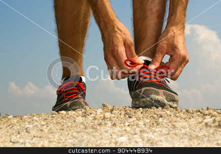 To use this stock image in your creative project, please select the size you need over to the right and click the "Add to Cart" button.
Your downloaded image will come with the Cutcaster watermark removed so don’t worry about the watermark you see on this page. Runner tying shoelaces stock photo, Runner tying his shoelaces before training by Roland Valentin Raicu