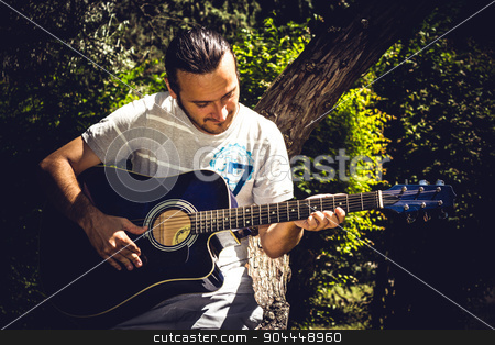 To use this stock image in your creative project, please select the size you need over to the right and click the "Add to Cart" button.
Your downloaded image will come with the Cutcaster watermark removed so don’t worry about the watermark you see on this page. Guitar Player stock photo, Guitar player singing in a park sitting on a tree by Roland Valentin Raicu