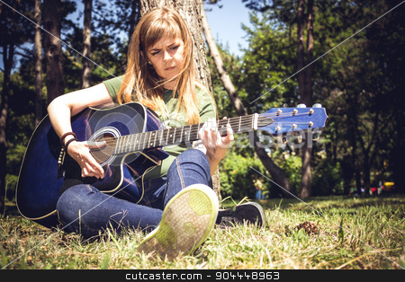 To use this stock image in your creative project, please select the size you need over to the right and click the "Add to Cart" button.
Your downloaded image will come with the Cutcaster watermark removed so don’t worry about the watermark you see on this page. Guitar Player stock photo, Girl singing to a guitar surrounded by trees in a park by Roland Valentin Raicu
