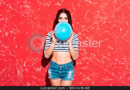 To use this stock image in your creative project, please select the size you need over to the right and click the "Add to Cart" button.
Your downloaded image will come with the Cutcaster watermark removed so don’t worry about the watermark you see on this page. Creative concept of beautiful sexy girl stock photo, Colorful picture of beautiful slim young woman with long hair on red background. Girl looking at camera and inflating blue baloon by Dmytro Sidelnikov