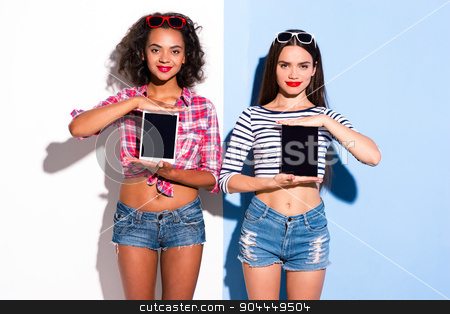 To use this stock image in your creative project, please select the size you need over to the right and click the "Add to Cart" button.
Your downloaded image will come with the Cutcaster watermark removed so don’t worry about the watermark you see on this page. Funky couple. Creative concept of beautiful sexy girls. stock photo, Colorful picture of beautiful slim young women on white and blue background. Girls smiling and holding tablet computers by Dmytro Sidelnikov