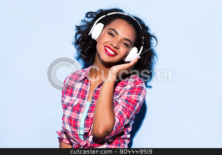 To use this stock image in your creative project, please select the size you need over to the right and click the "Add to Cart" button.
Your downloaded image will come with the Cutcaster watermark removed so don’t worry about the watermark you see on this page. Creative concept of beautiful sexy girl stock photo, Colorful picture of beautiful slim young woman with curly hair on white background. Girl with headphones smiling and listening to music with her eyes closed by Dmytro Sidelnikov