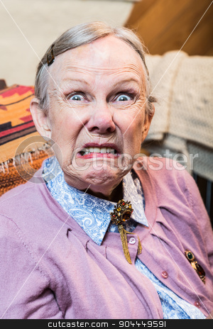 To use this stock image in your creative project, please select the size you need over to the right and click the "Add to Cart" button.
Your downloaded image will come with the Cutcaster watermark removed so don’t worry about the watermark you see on this page. Old Woman Making a Face stock photo, Woman making a scary face at the camera by Scott Griessel