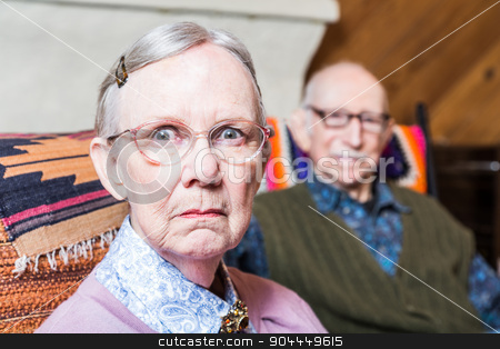To use this stock image in your creative project, please select the size you need over to the right and click the "Add to Cart" button.
Your downloaded image will come with the Cutcaster watermark removed so don’t worry about the watermark you see on this page. Serious Man and Woman Indoors stock photo, Old couple seating in livingroom woman scowling by Scott Griessel