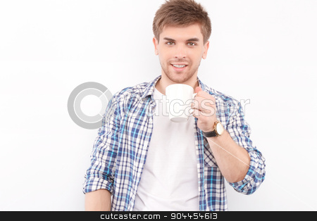 To use this stock image in your creative project, please select the size you need over to the right and click the "Add to Cart" button.
Your downloaded image will come with the Cutcaster watermark removed so don’t worry about the watermark you see on this page. Handsome man isolated on white stock photo, Portrait of a handsome young man standing looking at the camera smiling and holding a cup of coffee in his hands preparing for drinking, isolated in white background by Zinkevych