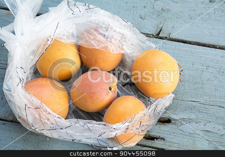 To use this stock image in your creative project, please select the size you need over to the right and click the "Add to Cart" button.
Your downloaded image will come with the Cutcaster watermark removed so don’t worry about the watermark you see on this page. Fresh apricots in a transparent plastic bag on old blue-gray woo stock photo, apricots fresh from the market in a transparent plastic bag on old blue-gray wood by Maren Winter