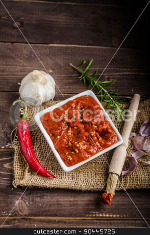 To use this stock image in your creative project, please select the size you need over to the right and click the "Add to Cart" button.
Your downloaded image will come with the Cutcaster watermark removed so don’t worry about the watermark you see on this page. Very spicy tomato sauce for grill stock photo, Very spicy tomato sauce with pieces of chilli and garlic, herbs by Peteer
