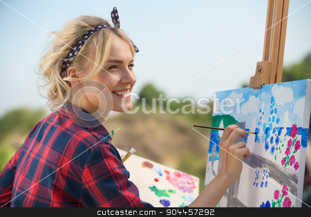 To use this stock image in your creative project, please select the size you need over to the right and click the "Add to Cart" button.
Your downloaded image will come with the Cutcaster watermark removed so don’t worry about the watermark you see on this page. Beautiful blonde woman artist paints a colorful picture. stock photo, Beautiful blonde woman artist in a playful mood dressed in a plaid shirt. She paints a picture with a brush and paints nature by bezikus