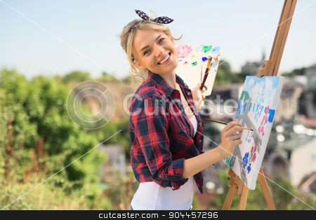 To use this stock image in your creative project, please select the size you need over to the right and click the "Add to Cart" button.
Your downloaded image will come with the Cutcaster watermark removed so don’t worry about the watermark you see on this page. Beautiful blonde woman artist paints a colorful picture. stock photo, Beautiful blonde woman artist in a playful mood dressed in a plaid shirt. She paints a picture with a brush and paints nature by bezikus