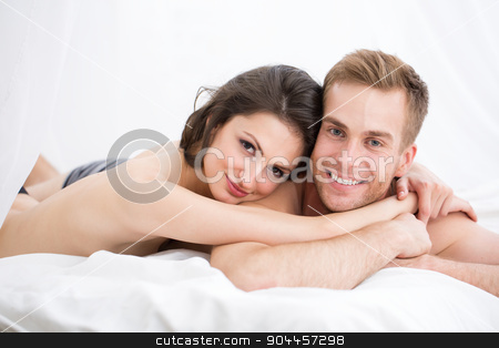 To use this stock image in your creative project, please select the size you need over to the right and click the "Add to Cart" button.
Your downloaded image will come with the Cutcaster watermark removed so don’t worry about the watermark you see on this page. Happy young couple lying in white bed stock photo, Happy young couple lying in white bed, looking at the camera. Girl hugging guy. Morning light. by bezikus