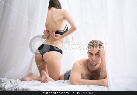 To use this stock image in your creative project, please select the size you need over to the right and click the "Add to Cart" button.
Your downloaded image will come with the Cutcaster watermark removed so don’t worry about the watermark you see on this page. Sad morning in the bedroom of a young couple stock photo, Sad morning in the bedroom of a young couple. She undoes her bra back to the camera. Man lying on stomach propped a hand face with a sad emotion. by bezikus