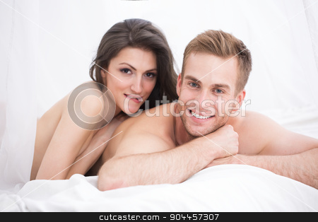 To use this stock image in your creative project, please select the size you need over to the right and click the "Add to Cart" button.
Your downloaded image will come with the Cutcaster watermark removed so don’t worry about the watermark you see on this page. Happy young couple lying in white bed stock photo, Happy young couple lying in white bed, looking at the camera. Girl hugging guy. Morning light. by bezikus