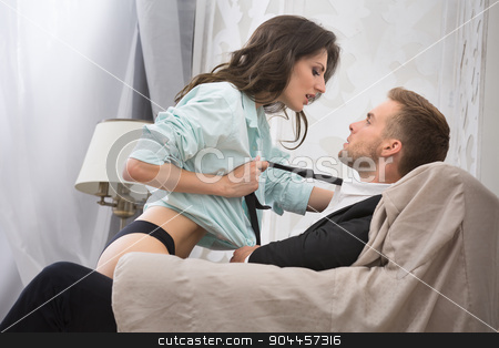To use this stock image in your creative project, please select the size you need over to the right and click the "Add to Cart" button.
Your downloaded image will come with the Cutcaster watermark removed so don’t worry about the watermark you see on this page. Sexy brunette seduced a guy in business suit stock photo, Sexy brunette seduced a guy in a business suit pulling him by the tie to kiss. Couple sitting in a large armchair. Photographed in a studio interior. by bezikus