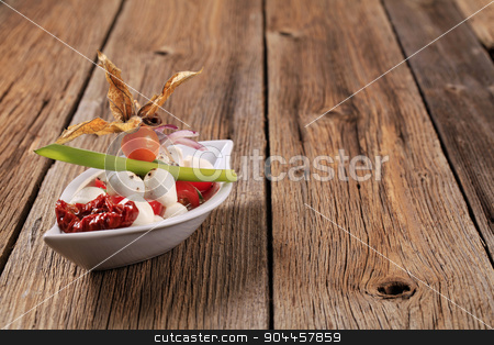 To use this stock image in your creative project, please select the size you need over to the right and click the "Add to Cart" button.
Your downloaded image will come with the Cutcaster watermark removed so don’t worry about the watermark you see on this page. Caprese salad stock photo, Baby mozzarella and tomato salad in a bowl by Digifoodstock