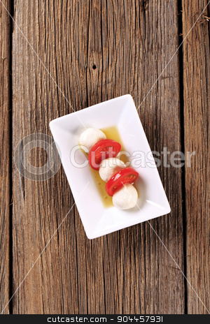To use this stock image in your creative project, please select the size you need over to the right and click the "Add to Cart" button.
Your downloaded image will come with the Cutcaster watermark removed so don’t worry about the watermark you see on this page. Mozzarella cheese and tomato stock photo, Marinated mozzarella cheese balls and fresh tomato by Digifoodstock