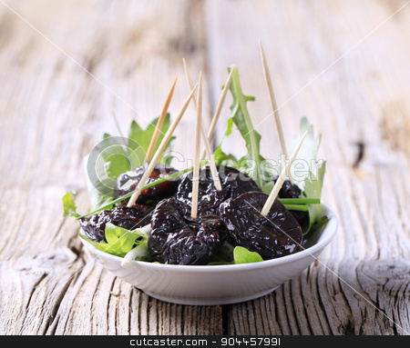 To use this stock image in your creative project, please select the size you need over to the right and click the "Add to Cart" button.
Your downloaded image will come with the Cutcaster watermark removed so don’t worry about the watermark you see on this page. Glazed prunes stock photo, Glazed prunes on a nest of salad greens by Digifoodstock
