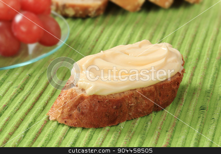 To use this stock image in your creative project, please select the size you need over to the right and click the "Add to Cart" button.
Your downloaded image will come with the Cutcaster watermark removed so don’t worry about the watermark you see on this page. Bread and cheese spread stock photo, Slice of bread roll and creamy cheese spread by Digifoodstock