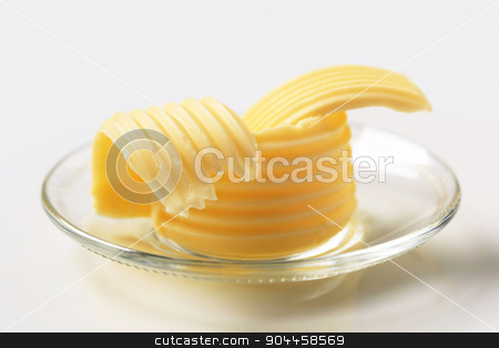 To use this stock image in your creative project, please select the size you need over to the right and click the "Add to Cart" button.
Your downloaded image will come with the Cutcaster watermark removed so don’t worry about the watermark you see on this page. Butter curls stock photo, Butter curls on glass plate by Digifoodstock