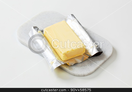 To use this stock image in your creative project, please select the size you need over to the right and click the "Add to Cart" button.
Your downloaded image will come with the Cutcaster watermark removed so don’t worry about the watermark you see on this page. Block of fresh butter stock photo, Block of fresh butter on a cutting board by Digifoodstock
