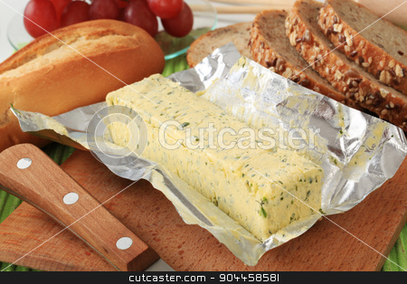 To use this stock image in your creative project, please select the size you need over to the right and click the "Add to Cart" button.
Your downloaded image will come with the Cutcaster watermark removed so don’t worry about the watermark you see on this page. Herb butter stock photo, Stick of fresh herb butter and bread by Digifoodstock