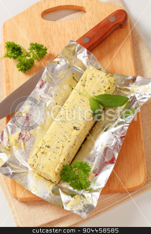 To use this stock image in your creative project, please select the size you need over to the right and click the "Add to Cart" button.
Your downloaded image will come with the Cutcaster watermark removed so don’t worry about the watermark you see on this page. Herb butter stock photo, Stick of fresh herb butter - studio by Digifoodstock