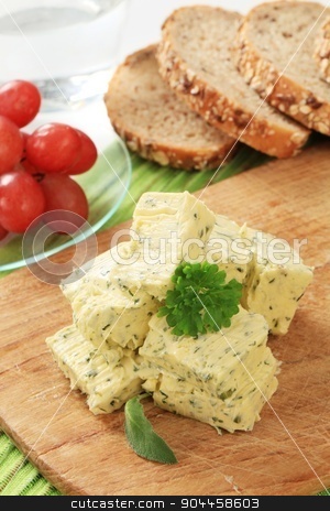 To use this stock image in your creative project, please select the size you need over to the right and click the "Add to Cart" button.
Your downloaded image will come with the Cutcaster watermark removed so don’t worry about the watermark you see on this page. Herb butter stock photo, Stick of fresh herb butter on a cutting board by Digifoodstock