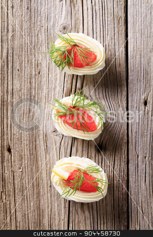 To use this stock image in your creative project, please select the size you need over to the right and click the "Add to Cart" button.
Your downloaded image will come with the Cutcaster watermark removed so don’t worry about the watermark you see on this page. Hors d'oeuvres stock photo, Boiled egg whites filled with red caviar by Digifoodstock