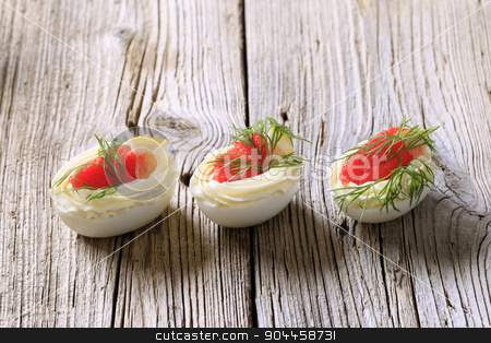 To use this stock image in your creative project, please select the size you need over to the right and click the "Add to Cart" button.
Your downloaded image will come with the Cutcaster watermark removed so don’t worry about the watermark you see on this page. Hors d'oeuvres stock photo, Boiled egg whites filled with red caviar by Digifoodstock