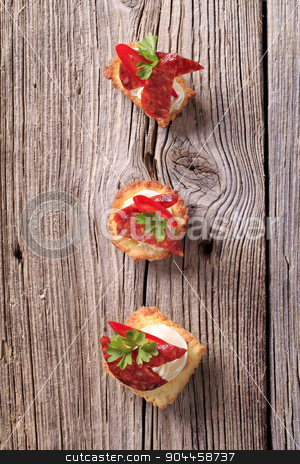 To use this stock image in your creative project, please select the size you need over to the right and click the "Add to Cart" button.
Your downloaded image will come with the Cutcaster watermark removed so don’t worry about the watermark you see on this page. Tartlet canapes stock photo, Tartlet based canapes with pieces of spicy salami by Digifoodstock