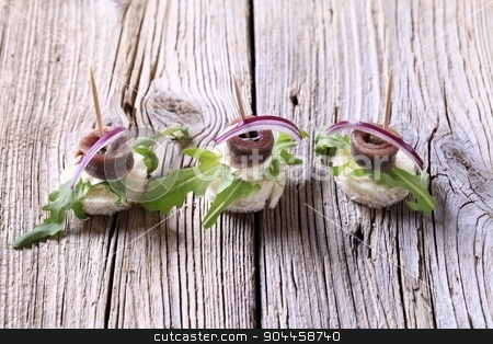 To use this stock image in your creative project, please select the size you need over to the right and click the "Add to Cart" button.
Your downloaded image will come with the Cutcaster watermark removed so don’t worry about the watermark you see on this page. Anchovy canapes stock photo, Anchovy canapes garnished with greens and onion by Digifoodstock