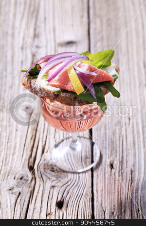 To use this stock image in your creative project, please select the size you need over to the right and click the "Add to Cart" button.
Your downloaded image will come with the Cutcaster watermark removed so don’t worry about the watermark you see on this page. Appetizer stock photo, Salmon sandwich on a glass of rose wine by Digifoodstock