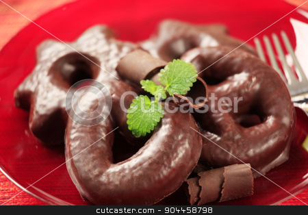 To use this stock image in your creative project, please select the size you need over to the right and click the "Add to Cart" button.
Your downloaded image will come with the Cutcaster watermark removed so don’t worry about the watermark you see on this page. Chocolate covered gingerbread cookies stock photo, Chocolate covered gingerbread cookies on a red plate by Digifoodstock