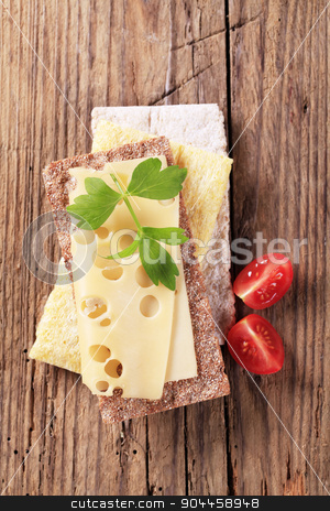 To use this stock image in your creative project, please select the size you need over to the right and click the "Add to Cart" button.
Your downloaded image will come with the Cutcaster watermark removed so don’t worry about the watermark you see on this page. Crispbread and cheese stock photo, Variety of crispbread and a slice of Swiss cheese by Digifoodstock