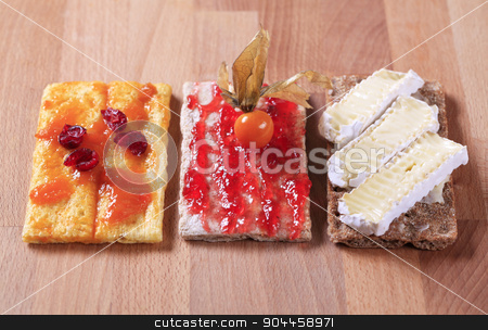To use this stock image in your creative project, please select the size you need over to the right and click the "Add to Cart" button.
Your downloaded image will come with the Cutcaster watermark removed so don’t worry about the watermark you see on this page. Crispbread with jam, marmalade and cheese stock photo, Crisp bread with jam, marmalade and cheese by Digifoodstock