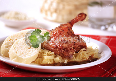 To use this stock image in your creative project, please select the size you need over to the right and click the "Add to Cart" button.
Your downloaded image will come with the Cutcaster watermark removed so don’t worry about the watermark you see on this page. Roast duck with sauerkraut and dumplings stock photo, Czech cuisine - Roast Duck Leg with Cabbage and Bread Dumplings by Digifoodstock