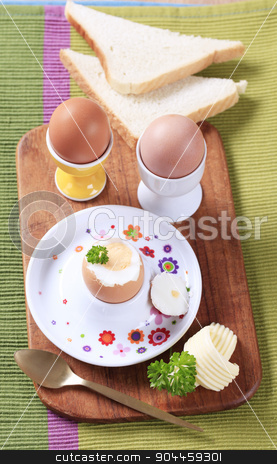 To use this stock image in your creative project, please select the size you need over to the right and click the "Add to Cart" button.
Your downloaded image will come with the Cutcaster watermark removed so don’t worry about the watermark you see on this page. Boiled eggs stock photo, Three boiled eggs in porcelain eggcups and white bread by Digifoodstock