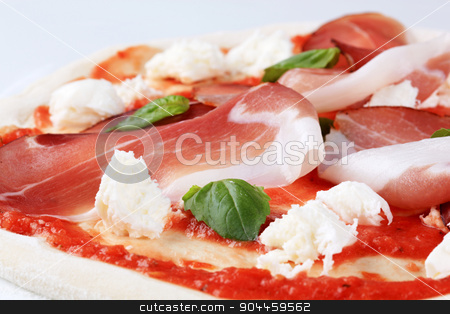 To use this stock image in your creative project, please select the size you need over to the right and click the "Add to Cart" button.
Your downloaded image will come with the Cutcaster watermark removed so don’t worry about the watermark you see on this page. Pizza proscuitto stock photo, Raw pizza dough with mozzarella and proscuitto on top by Digifoodstock