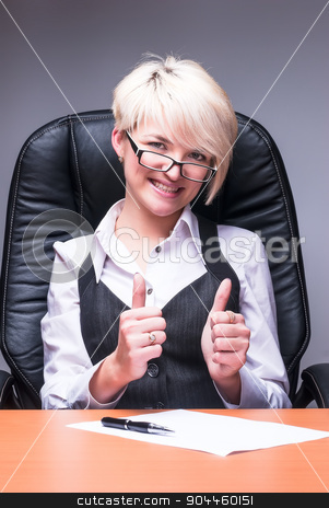 To use this stock image in your creative project, please select the size you need over to the right and click the "Add to Cart" button.
Your downloaded image will come with the Cutcaster watermark removed so don’t worry about the watermark you see on this page. Beautiful smiling business woman shows thumb up stock photo, Attractive blonde smiling business lady shows thumb up by Aikon