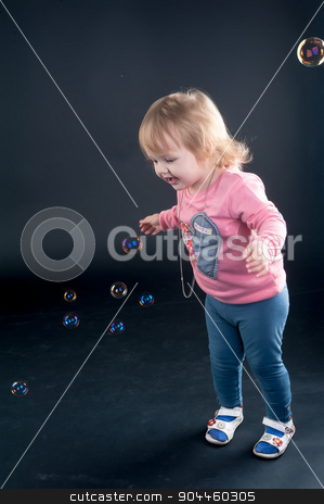 To use this stock image in your creative project, please select the size you need over to the right and click the "Add to Cart" button.
Your downloaded image will come with the Cutcaster watermark removed so don’t worry about the watermark you see on this page. Portrait of adorable young girl stock photo, Little girl catches soap bubbles over black background by Aikon