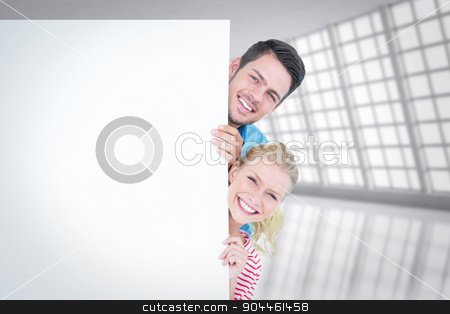 To use this stock image in your creative project, please select the size you need over to the right and click the "Add to Cart" button.
Your downloaded image will come with the Cutcaster watermark removed so don’t worry about the watermark you see on this page. Composite image of smiling young couple hiding behind a blank si stock photo, Smiling young couple hiding behind a blank sign against abstract room by Wavebreak Media