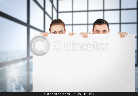 To use this stock image in your creative project, please select the size you need over to the right and click the "Add to Cart" button.
Your downloaded image will come with the Cutcaster watermark removed so don’t worry about the watermark you see on this page. Composite image of business partners hiding behind a sign stock photo, Business partners hiding behind a sign against room with large windows showing city by Wavebreak Media