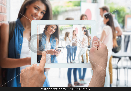 To use this stock image in your creative project, please select the size you need over to the right and click the "Add to Cart" button.
Your downloaded image will come with the Cutcaster watermark removed so don’t worry about the watermark you see on this page. Composite image of hand holding tablet pc stock photo, Hand holding tablet pc against pretty student smiling at camera with classmates behind by Wavebreak Media