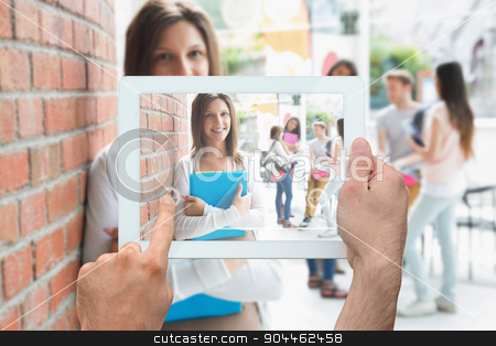 To use this stock image in your creative project, please select the size you need over to the right and click the "Add to Cart" button.
Your downloaded image will come with the Cutcaster watermark removed so don’t worry about the watermark you see on this page. Composite image of hand holding tablet pc stock photo, Hand holding tablet pc against pretty student smiling and holding notepads by Wavebreak Media